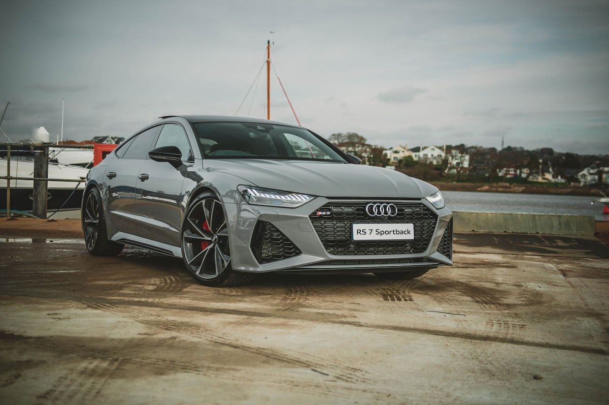 Clean, detailed sedan parked by the water
