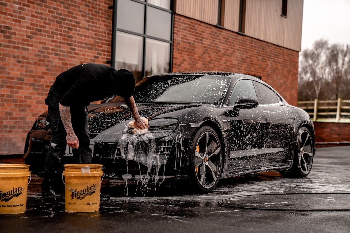 Hand foam-washing a car during a Poseidon mobile detail